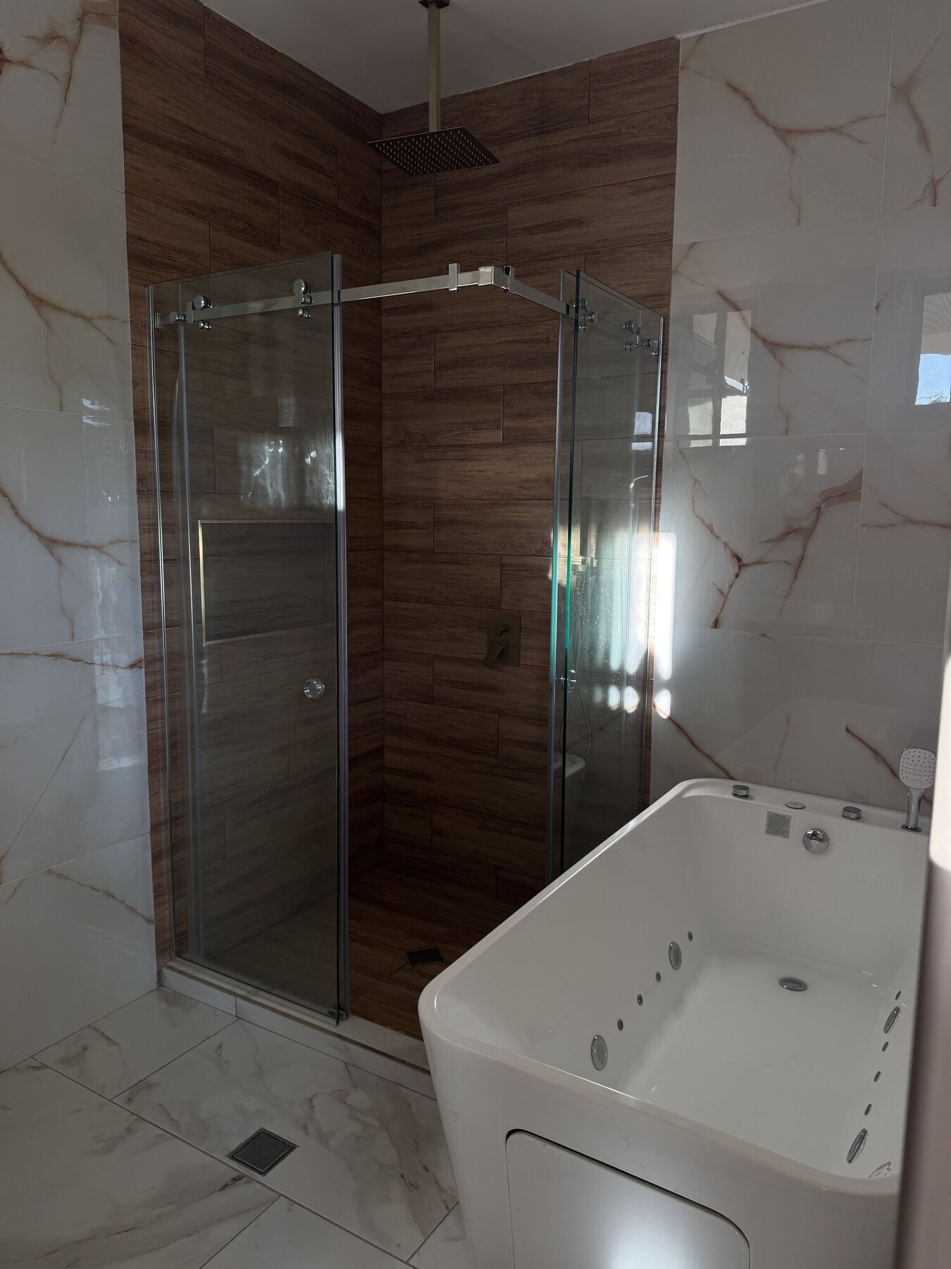 Baño con tina y ducha de vidrio · RV